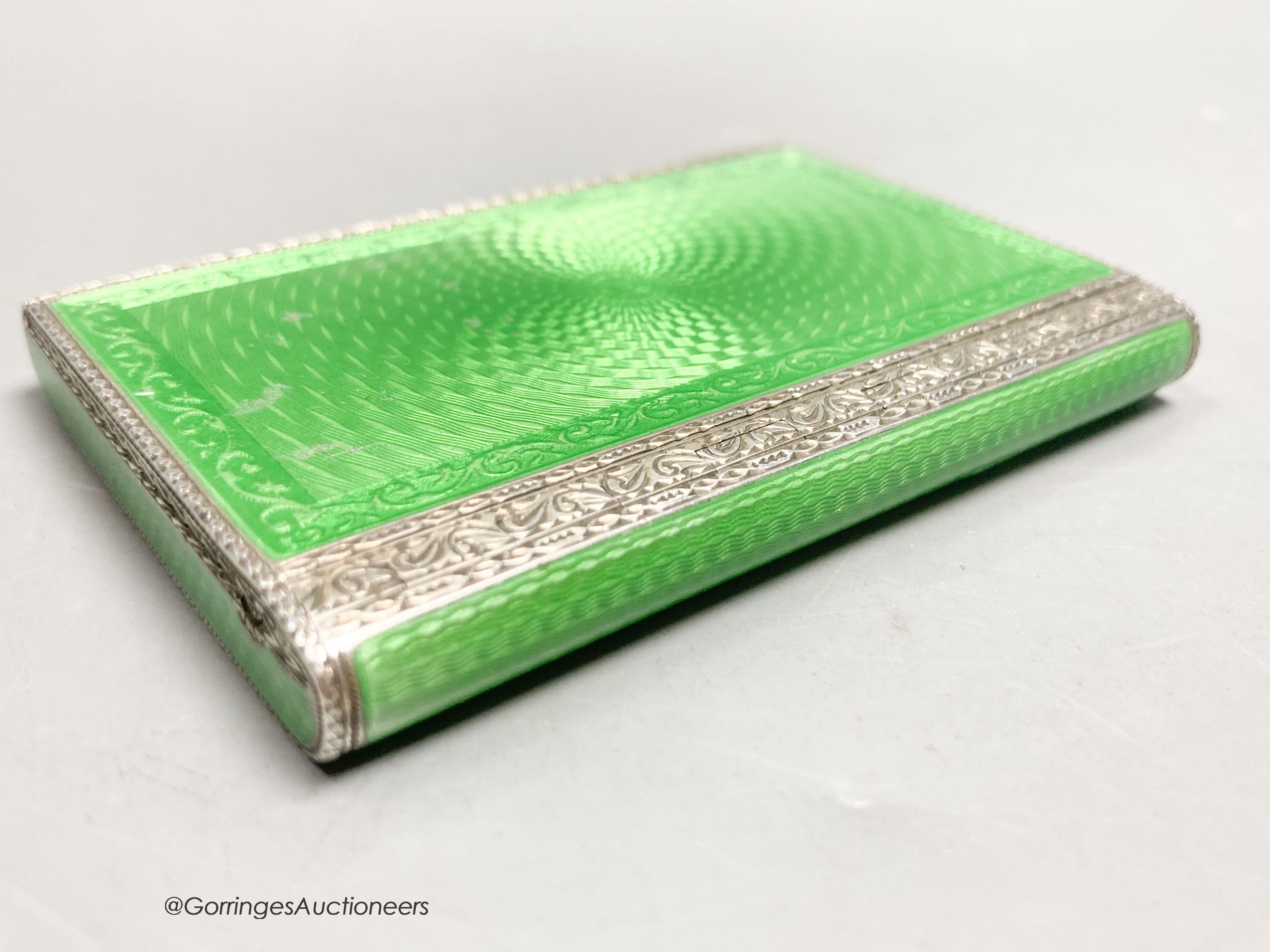 A 1920's continental silver and green guilloche enamel rectangular box and hinged cover, import marks for Cohen & Charles, London, 1927, 79mm by 54mm by 10mm